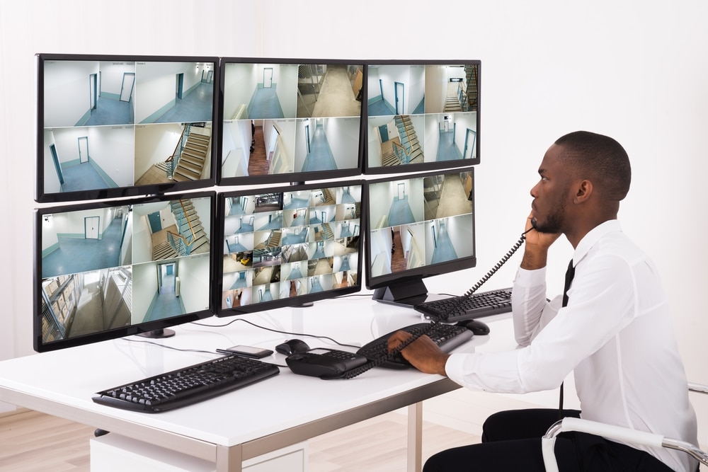 an image of a staff from a security company monitoring CCTV footage