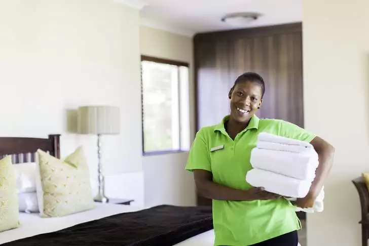 an image of a woman providing catering and housekeeping services