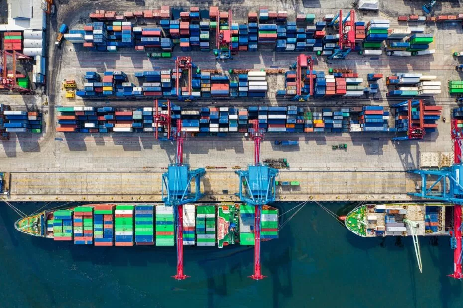 goods in ships and at a dock to show procurement and logistics at a port