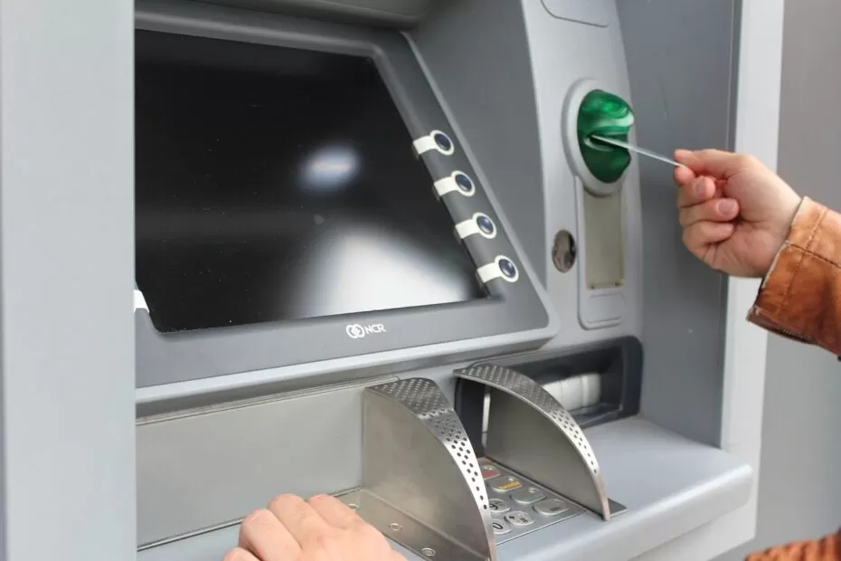 a person using an ATM at a bank branch